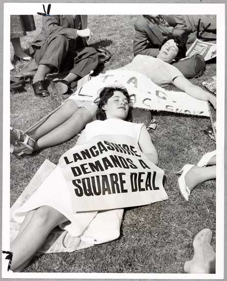 Cotton Protest March, 1962, L Blandford, Daily Herald Archive, ©National Media Museum Nineteen-year-old Jean Rogers, from Oldham and her friend Joan Hayes, take a quick breather in Hyde Park before joining 6000 other Lancashire cotton workers in a two-hour march through cheap cloth from India, Pakistan and Hong Kong.