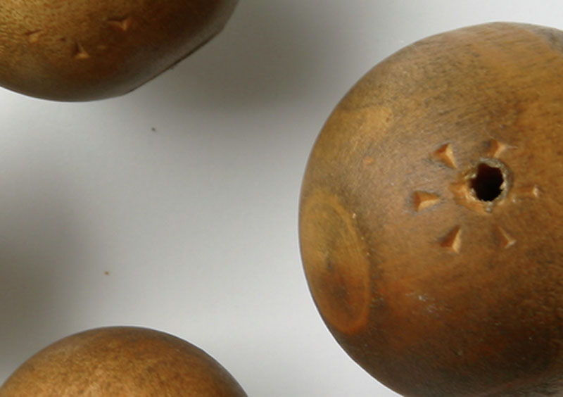 Close-up image of two of the wooden balls to show the indentations.