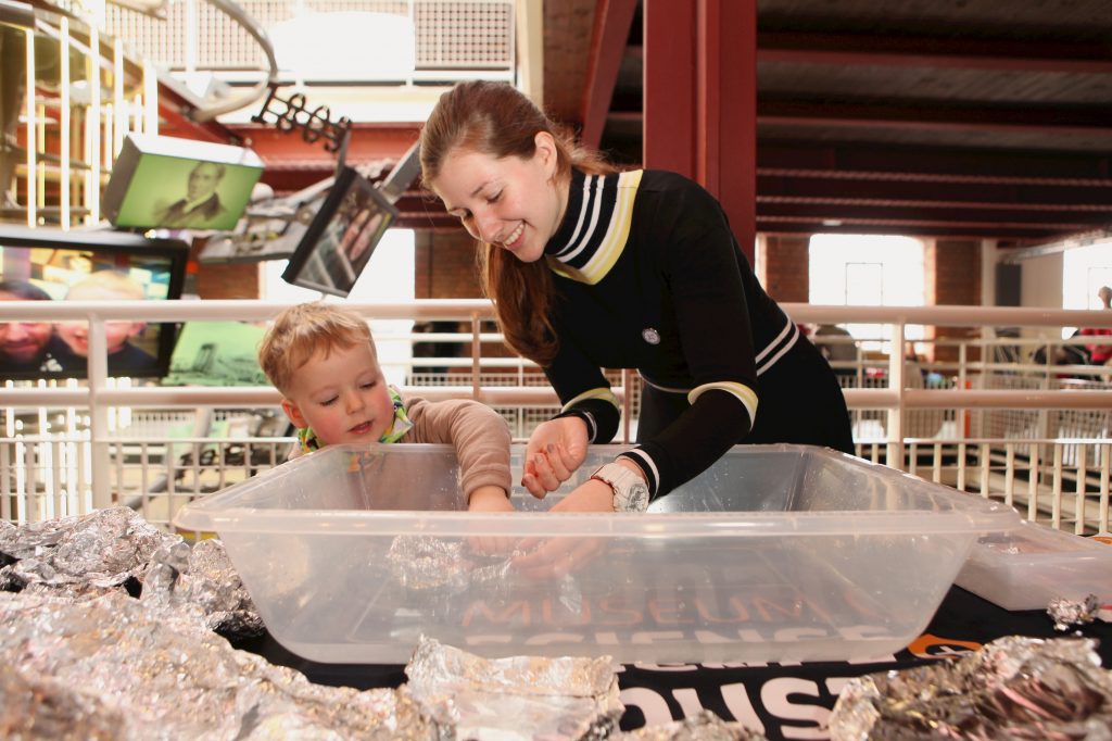 A woman and a child take part in an engineering-themed activity using tinfoil. Part of a blog post about female engineers.
