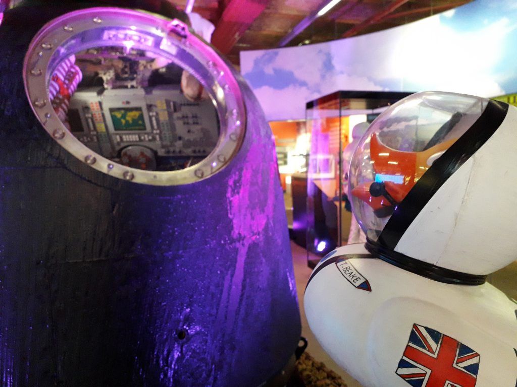 A rubber duck decorated like an astronaut, Tim Beake, admires astronaut Tim Peake's Soyuz spacecraft