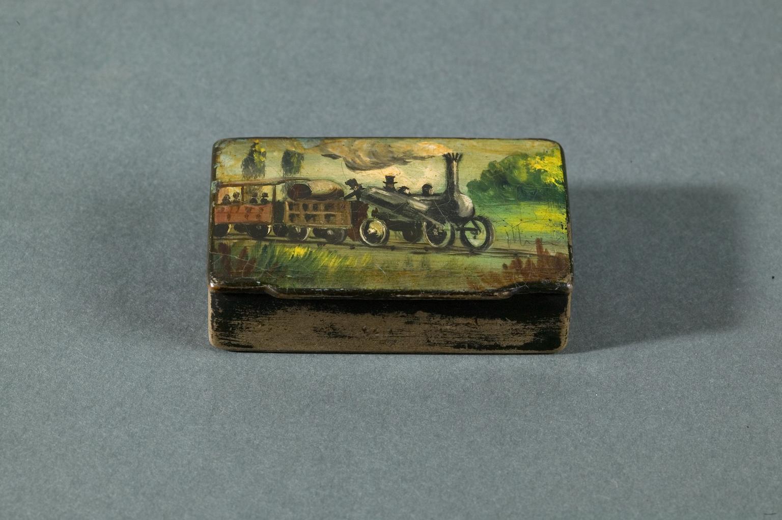 A snuff box with Stephenson's Rocket printed on it 