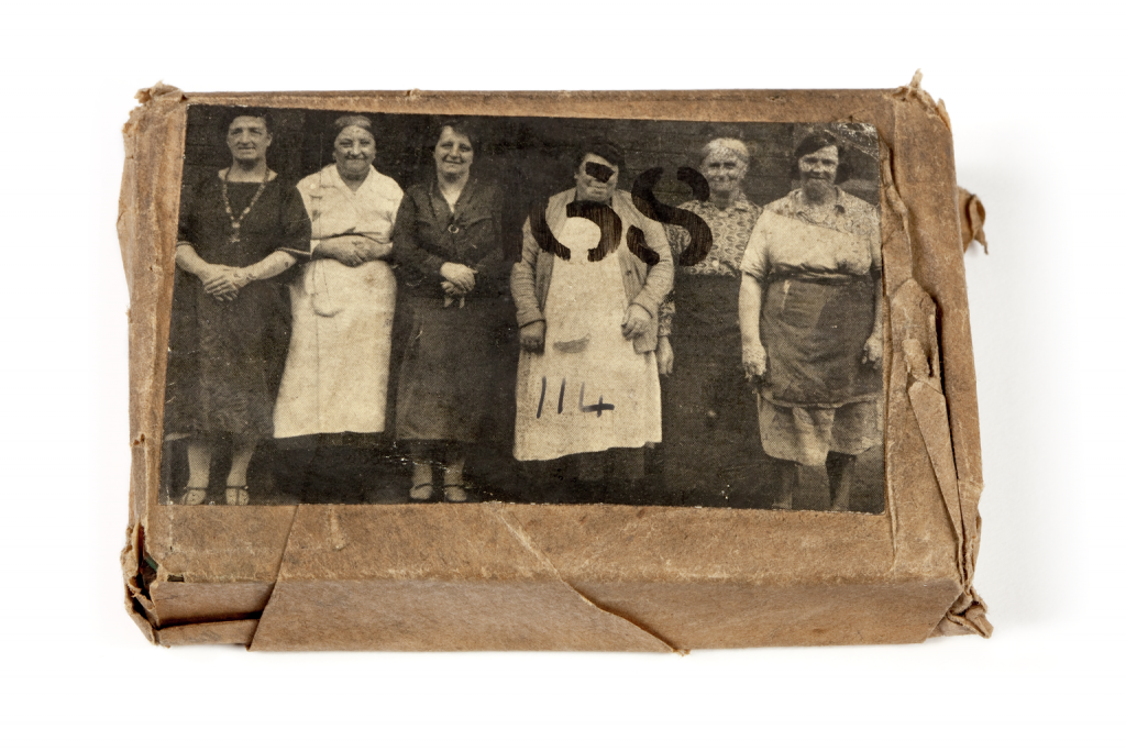 A printing block with a surface image of six ladies in a group