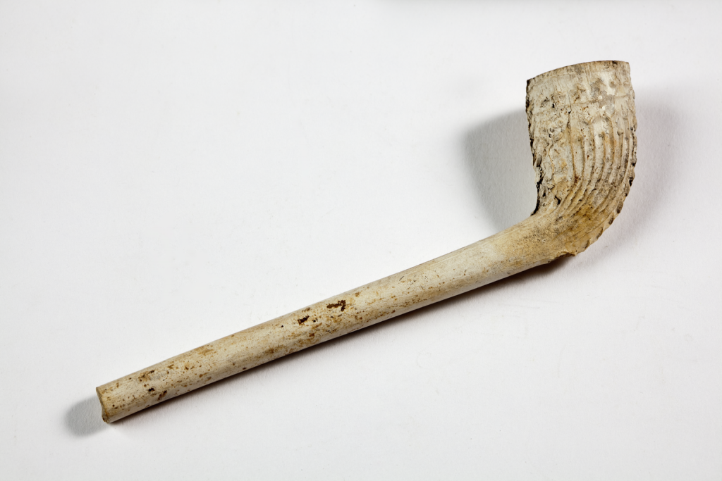 Clay pipe. Photographed from above on a white background.