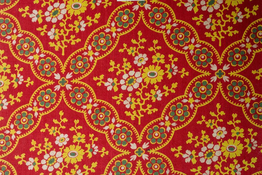 A red, green, yellow and white patterned fabric sample