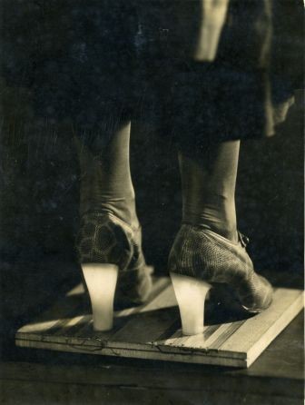 Sepia photo of a woman wearing high heels that light up