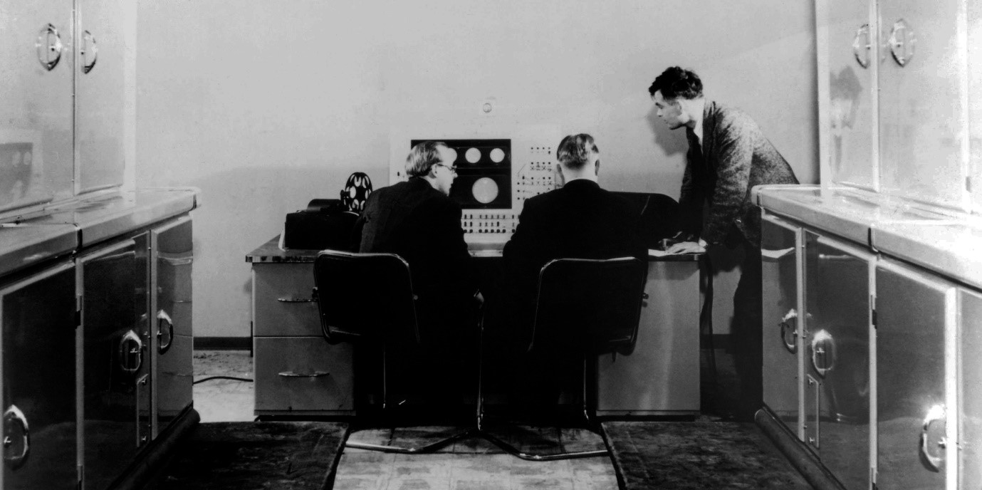 Alan Turing (right) and two Ferranti managers in a publicity shot for the new Ferranti Mark I