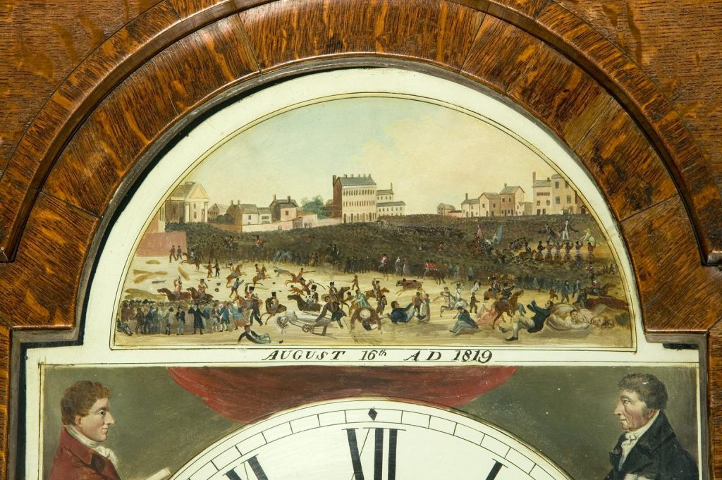 Closeup of the hand painted face, depicting the Peterloo Massacre