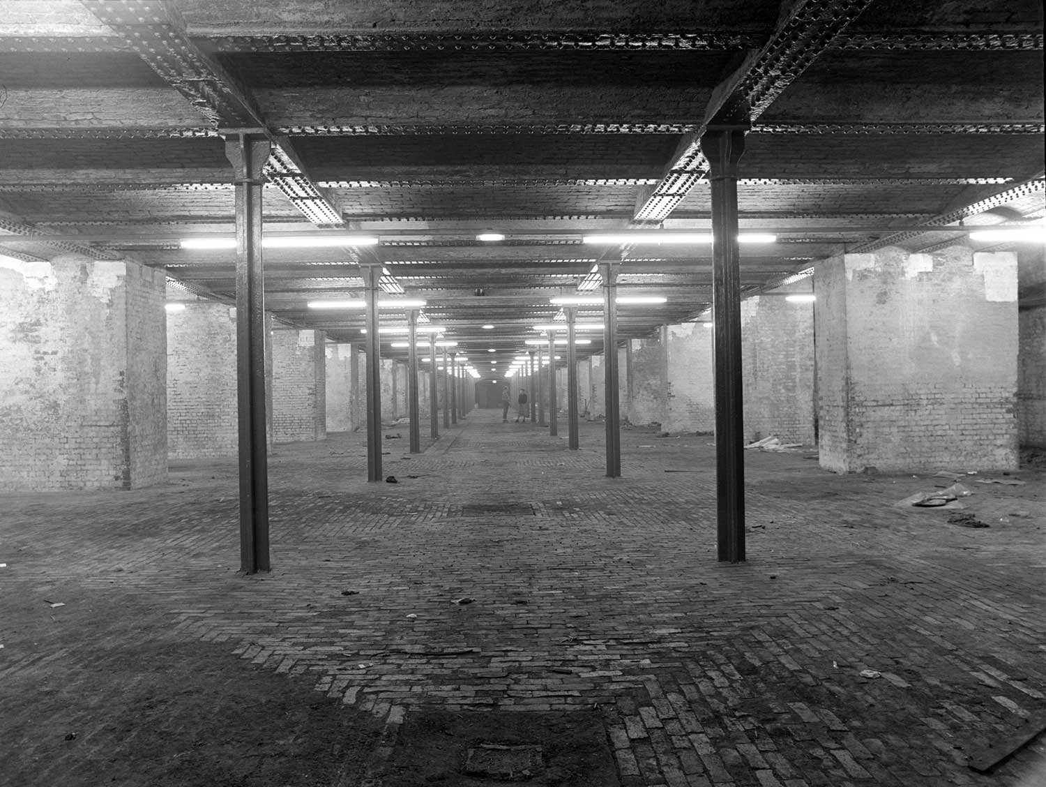 Black and white picture of the interior of a warehouse