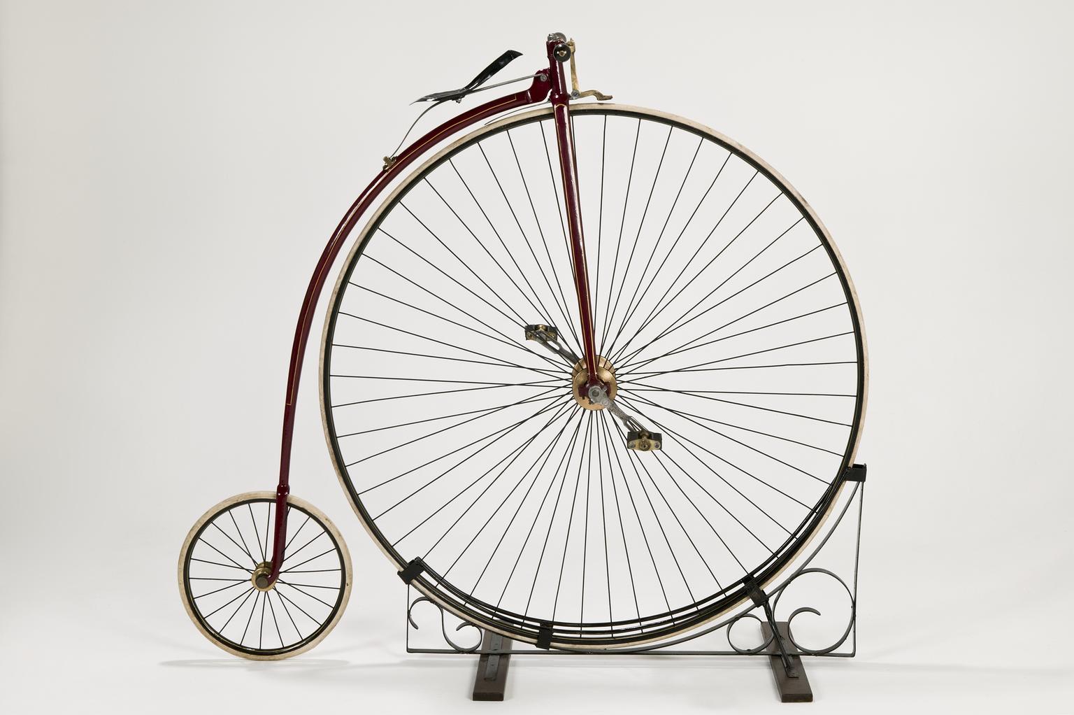A penny farthing bicycle, with one large front wheel and a small back wheel