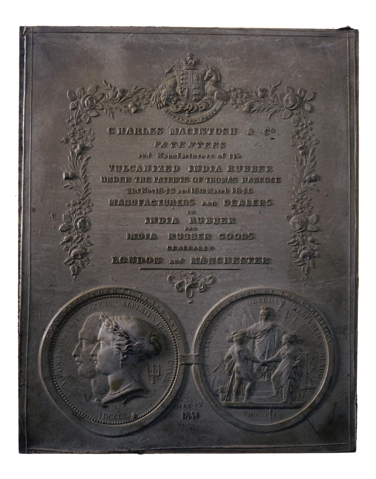 A grey plaque with some text and portraits of people on it