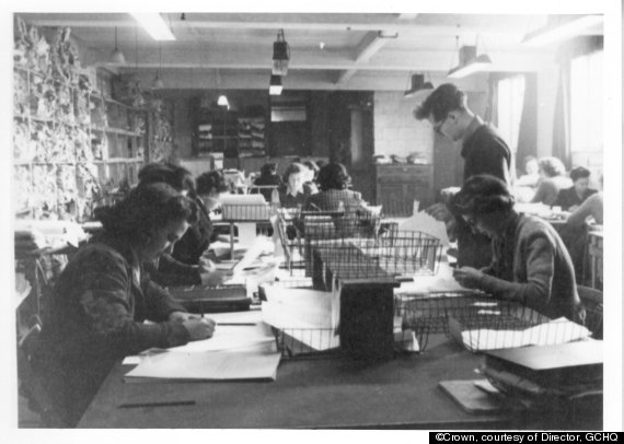 Black and white photo of women sat at desks working