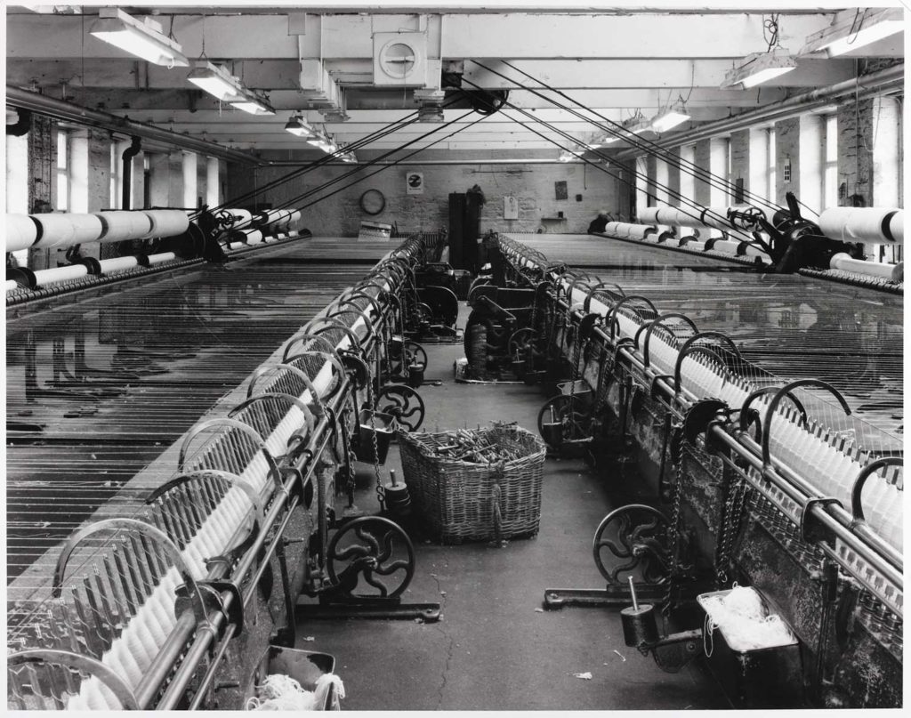 Black and white picture of cotton spinning machinery in a mill