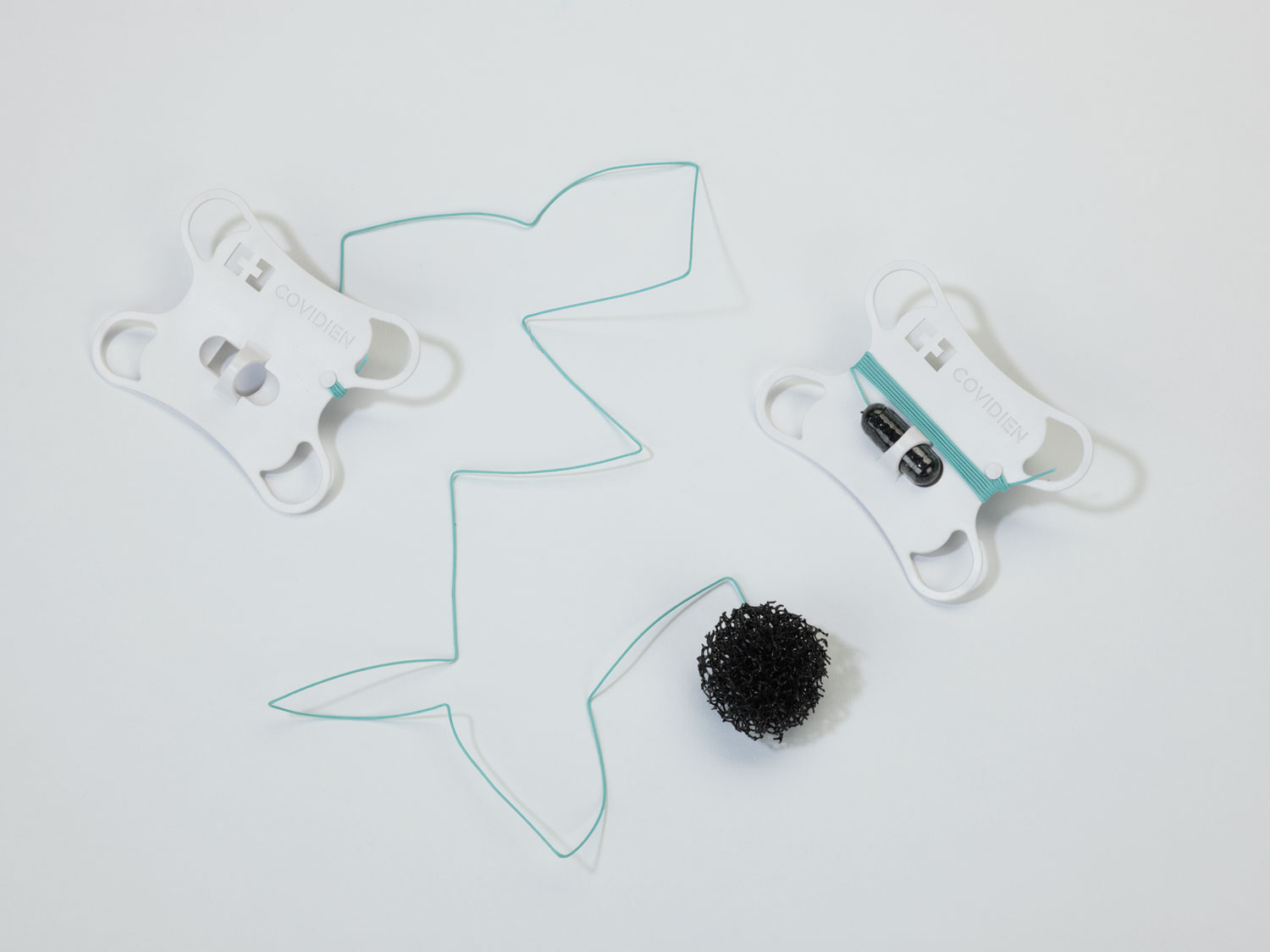 A black sponge ball at the end of a wire, attached to a white handle