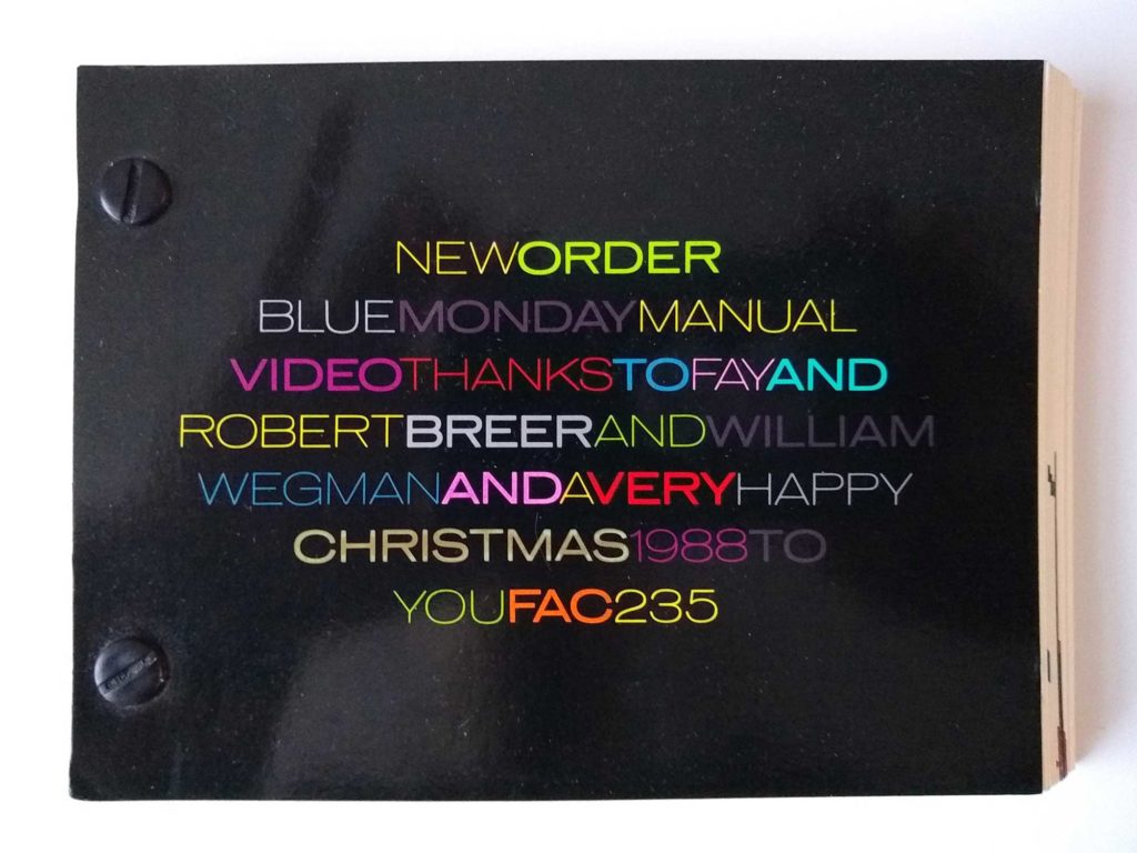 A black booklet with different coloured writing on it
