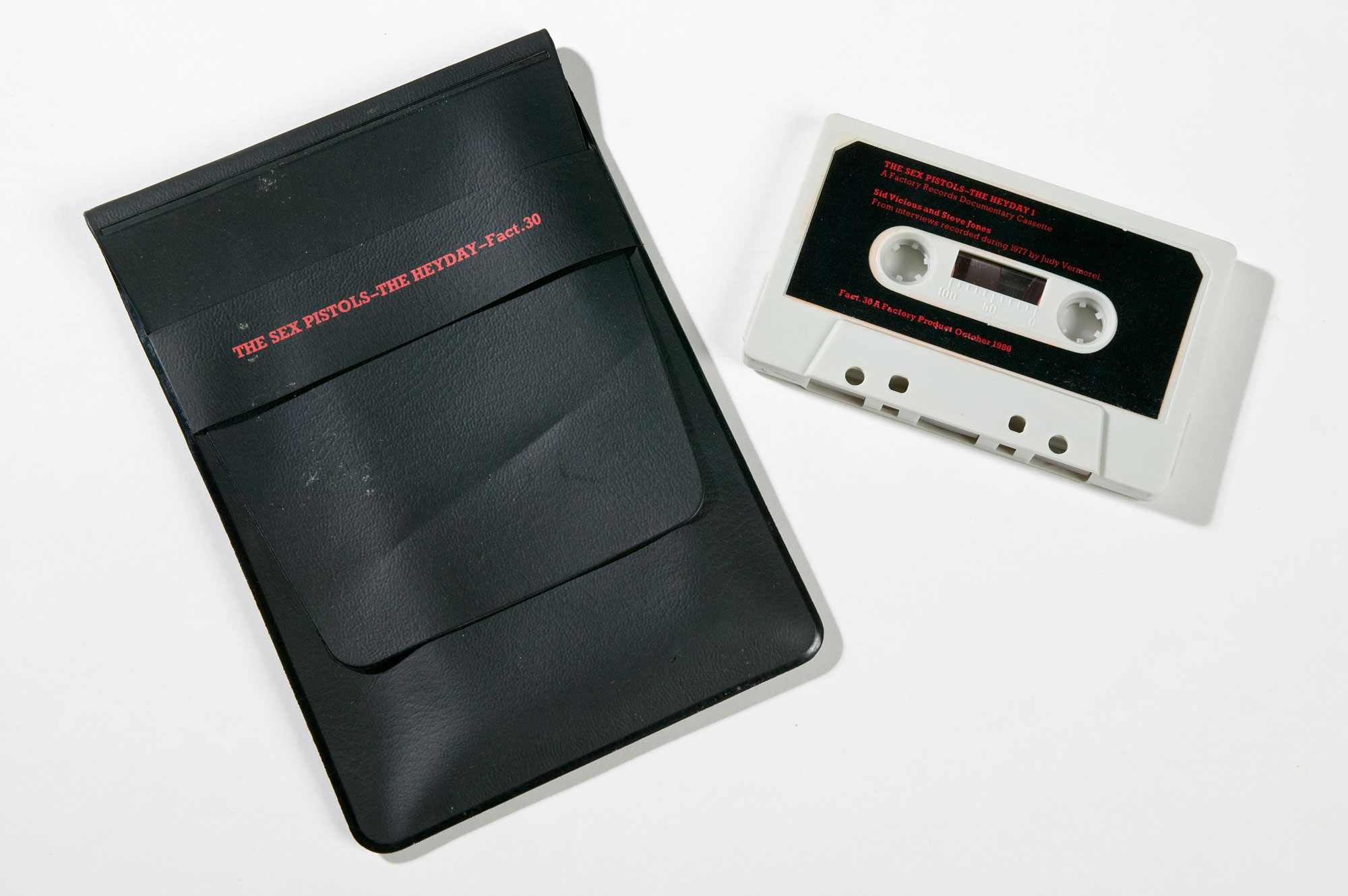 A white cassette tape and black pouch