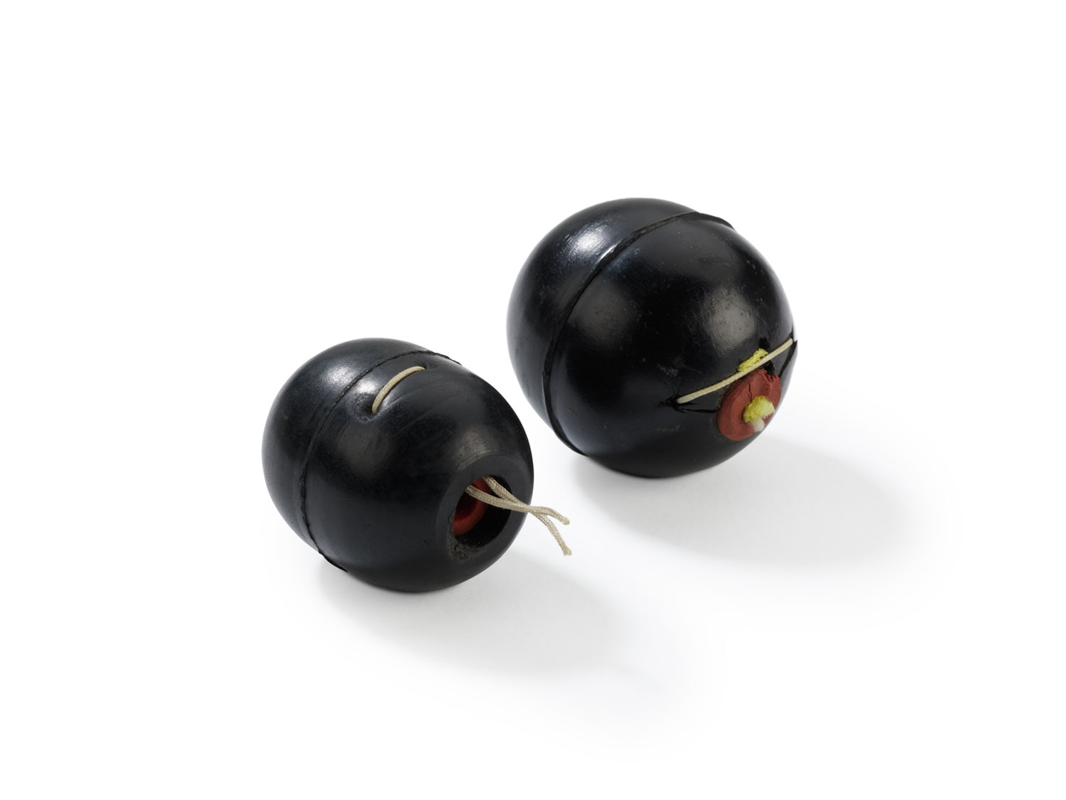 Two small black spherical medical devices