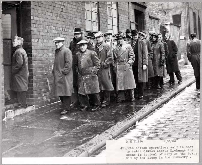 Slump 1952, 1952, White, Daily Herald Archive, ©National Media Museum Men cotton operatives wait in snow to enter Oldham Labour exchange the scene is typical of many towns hit by the slump in the industry.