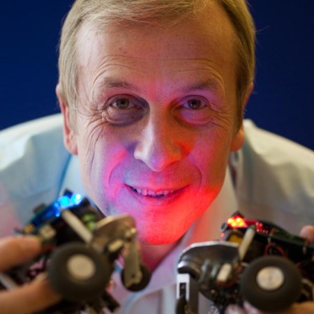 A man holding up two lights 