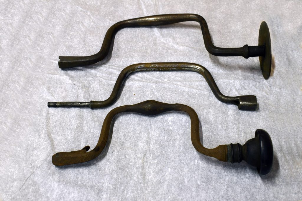 Three brass coloured metal hand drills 