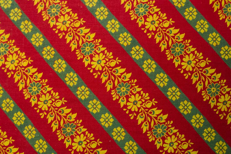 A red, yellow and green patterned fabric sample