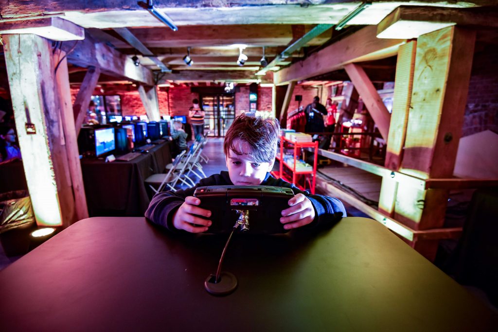 A boy holding a games console