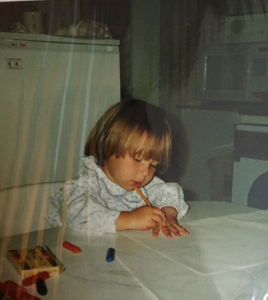 A child at a table drawing