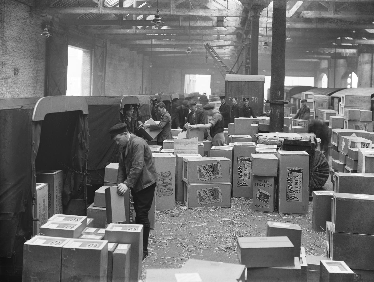 Tobacco boxes being transferred from rail to road vehicles at Manchester Liverpool Road station goods depot, 1934. Railway Museum/Science Museum Group