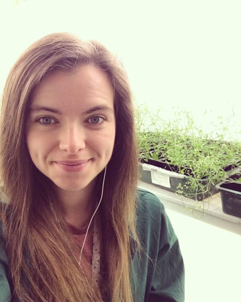 A woman stood in front of some plants
