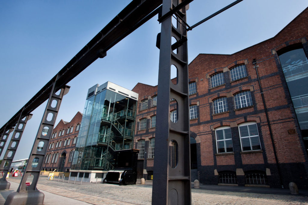 A warehouse with blue skies above it