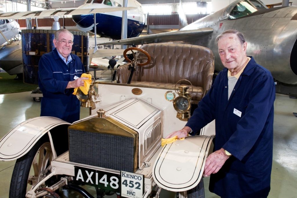 Two men polishing a car
