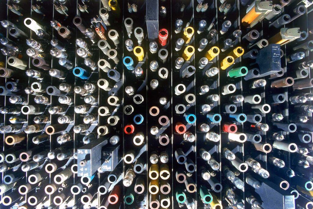 A component part of an early computer made of numerous plugs and valves