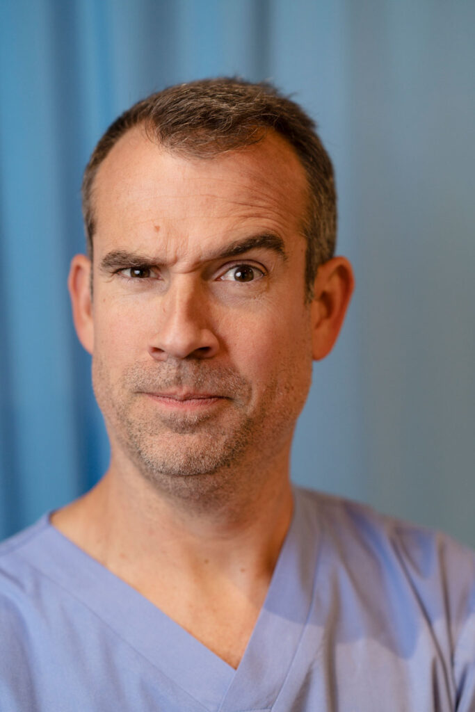 A man wearing blue doctors' scrubs