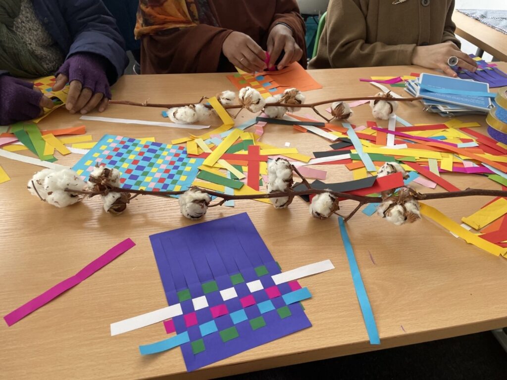 Participants doing paper weaving at a Cotton Connections workshop.Science Museum Group. 
