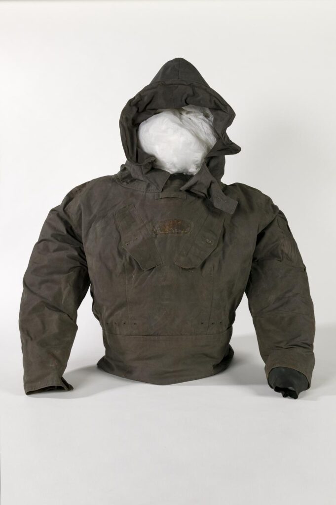 A dark green jacket on a mannequin