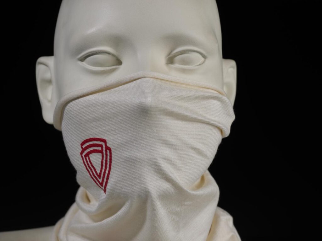 A white snood with red markings on a mannequin