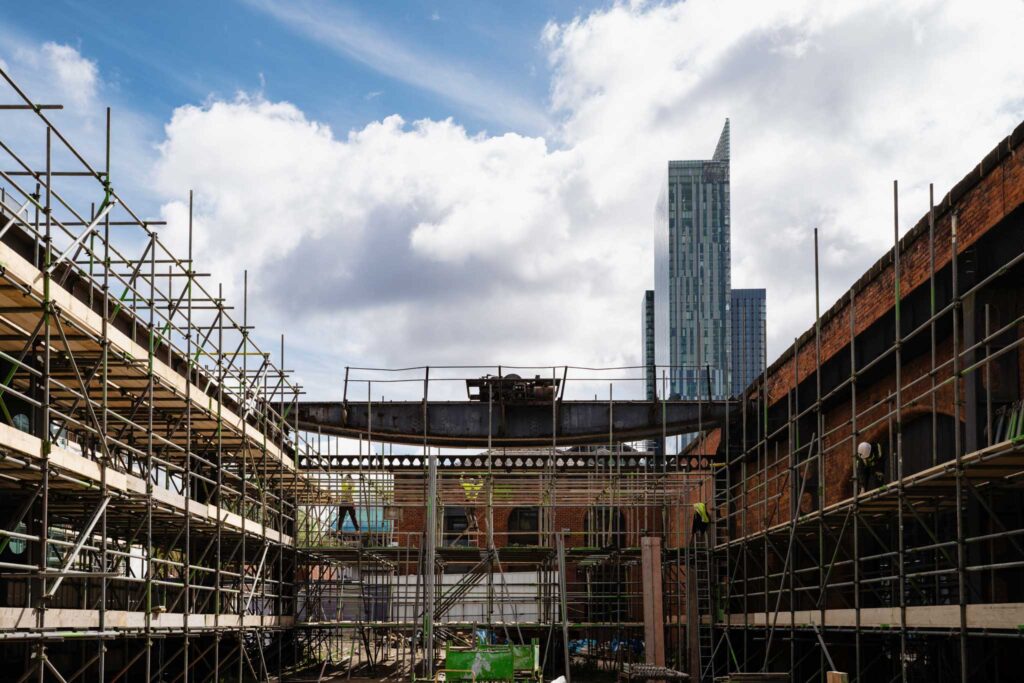Scaffolding being erected around some Victorian industrial machinery