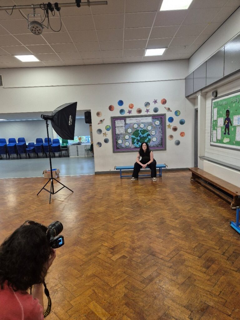 A woman posing for a photo in a primary school
