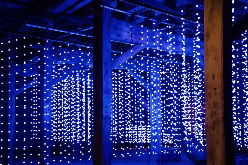 Blue spherical lights hanging from the ceiling of a warehouse