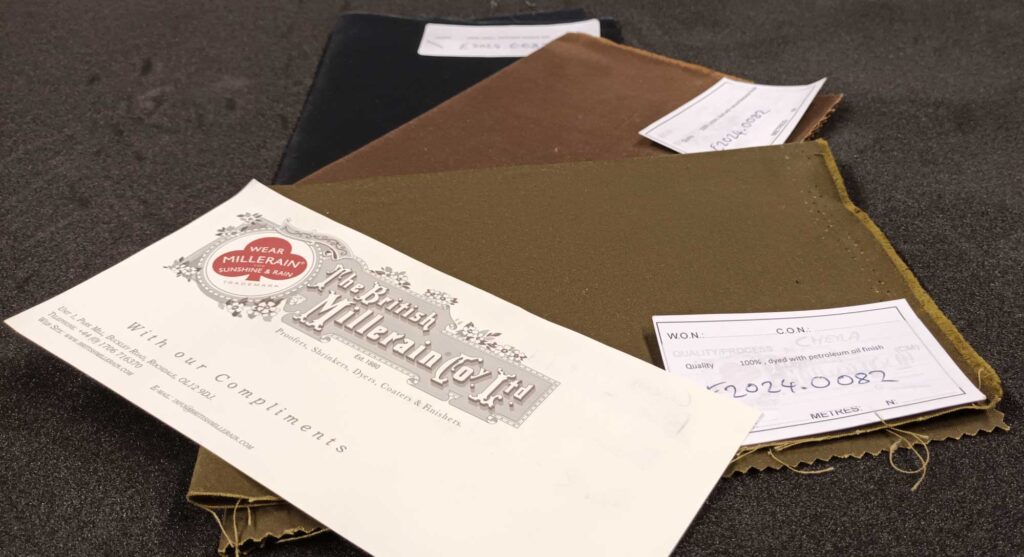 A piece of dark green fabric with a white label on it