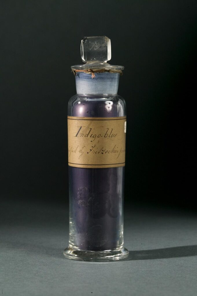 A glass vial of powdered indigo dye